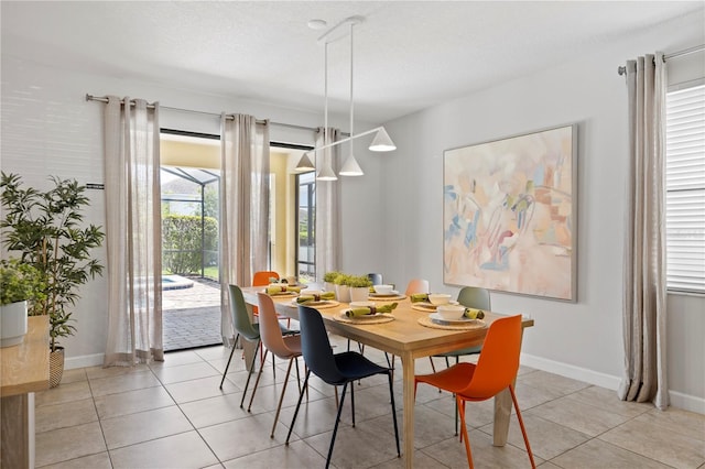 9023 Shadow Mountain St, Davenport, FL 33896 - dining space featuring light tile patterned floors and baseboards
