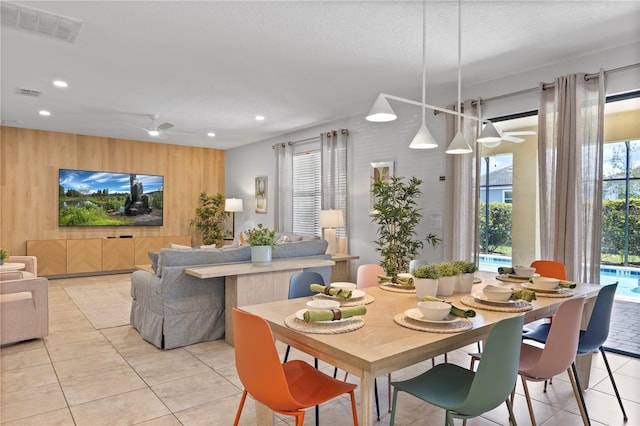 9023 Shadow Mountain St, Davenport, FL 33896 - dining space with wooden walls, ceiling fan, recessed lighting, and light tile patterned floors