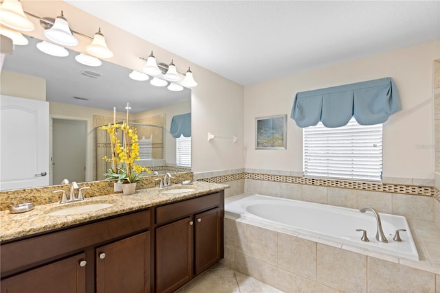 9023 Shadow Mountain St, Davenport, FL 33896 - bathroom with a shower stall, a garden tub, double vanity, and tile patterned flooring