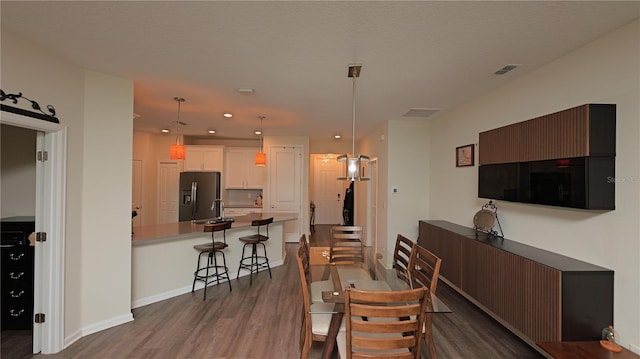 4858 Magnetite Loop, Mount Dora, FL 32757 - dining area with dark wood finished floors and recessed lighting
