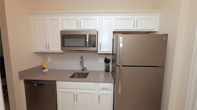 4858 Magnetite Loop, Mount Dora, FL 32757 - kitchen featuring stainless steel appliances, white cabinetry, backsplash, and light countertops