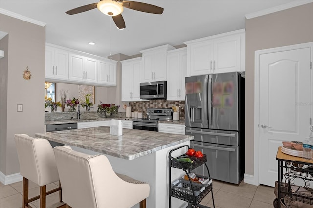 3508 Porta Romano Way, Lake Mary, FL 32746 - kitchen with stainless steel appliances, ceiling fan, light tile patterned flooring, decorative backsplash, and white cabinets