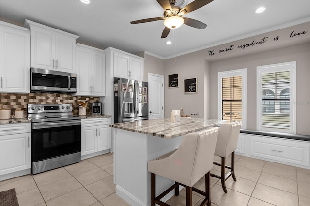 3508 Porta Romano Way, Lake Mary, FL 32746 - kitchen with stainless steel appliances, light tile patterned floors, decorative backsplash, a breakfast bar, and recessed lighting