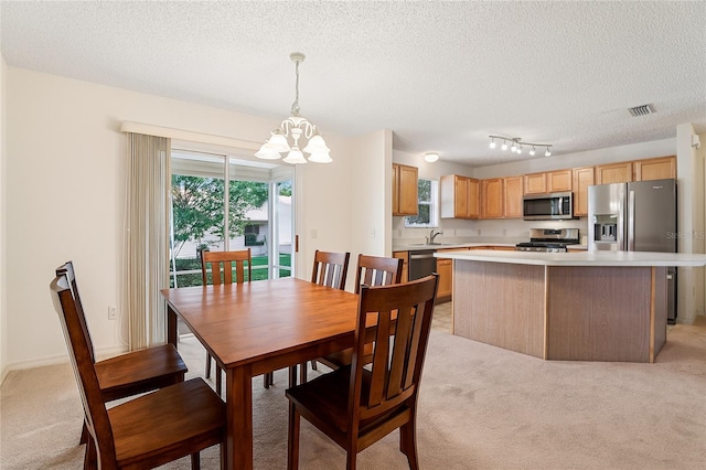 17097 SE 96th Chapelwood Cir, The Villages, FL 32162 - dining area with a chandelier, light carpet, and a textured ceiling