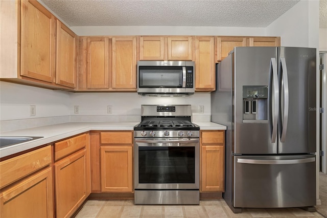 17097 SE 96th Chapelwood Cir, The Villages, FL 32162 - kitchen featuring stainless steel appliances, light countertops, and a textured ceiling