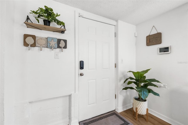 5141 Mallet Dr, Port Richey, FL 34668 - entryway featuring wood finished floors and a textured ceiling