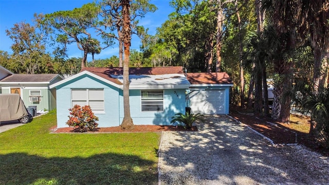 5141 Mallet Dr, Port Richey, FL 34668 - single story home with gravel driveway, a front yard, an attached garage, and stucco siding