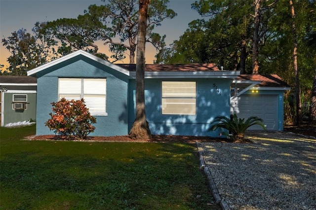 5141 Mallet Dr, Port Richey, FL 34668 - ranch-style house with a yard, stucco siding, and a garage
