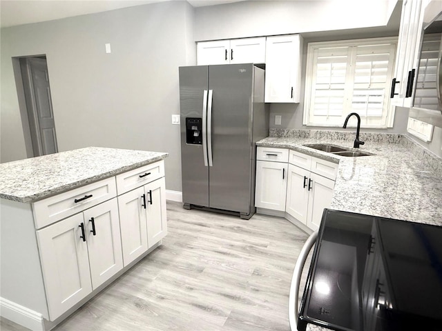 926 Freshmeadow Ct, Apopka, FL 32703 - kitchen featuring stainless steel fridge with ice dispenser, range, white cabinets, and light wood-style floors