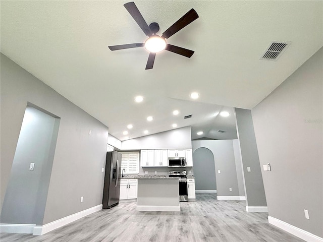 926 Freshmeadow Ct, Apopka, FL 32703 - kitchen with appliances with stainless steel finishes, lofted ceiling, ceiling fan, white cabinets, and light wood finished floors