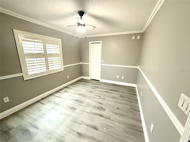 926 Freshmeadow Ct, Apopka, FL 32703 - empty room featuring ceiling fan, wood finished floors, a textured ceiling, and crown molding