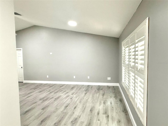 926 Freshmeadow Ct, Apopka, FL 32703 - unfurnished living room featuring wood finished floors, lofted ceiling, and healthy amount of natural light