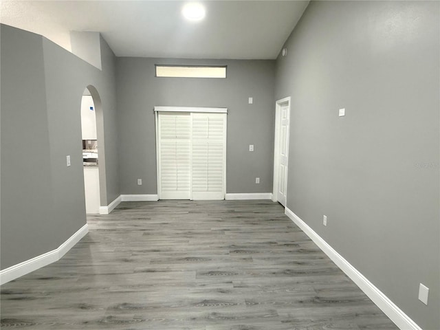 926 Freshmeadow Ct, Apopka, FL 32703 - unfurnished room featuring arched walkways, wood finished floors, and a high ceiling