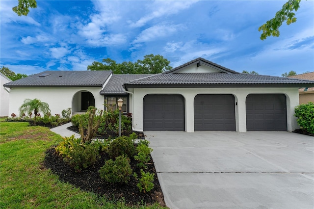 6019 Crystal View Dr, Orlando, FL 32819 - view of front of house featuring an attached garage, driveway, stucco siding, and a tiled roof