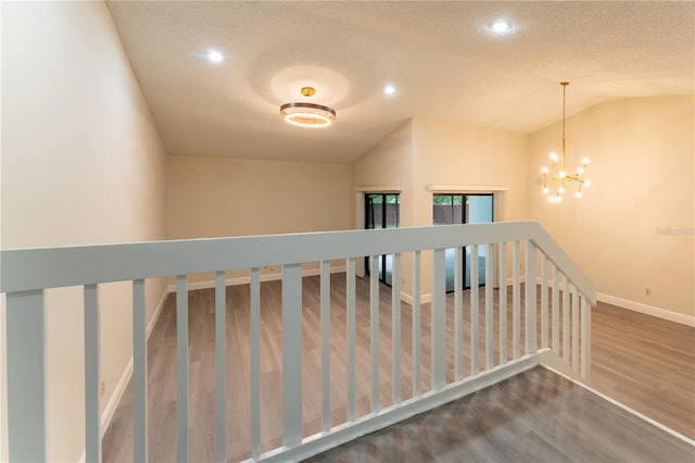 6019 Crystal View Dr, Orlando, FL 32819 - stairs featuring wood finished floors, recessed lighting, a chandelier, a textured ceiling, and vaulted ceiling