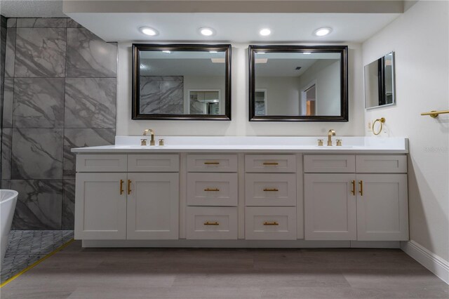6019 Crystal View Dr, Orlando, FL 32819 - bathroom featuring double vanity, wood finished floors, and a freestanding bath