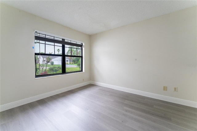 6019 Crystal View Dr, Orlando, FL 32819 - unfurnished room featuring wood finished floors and a textured ceiling