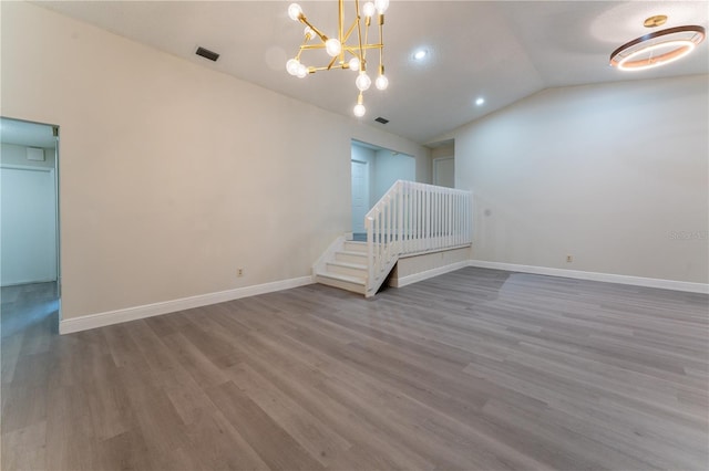 6019 Crystal View Dr, Orlando, FL 32819 - spare room with lofted ceiling, wood finished floors, a chandelier, and recessed lighting