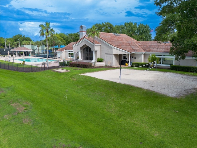 6019 Crystal View Dr, Orlando, FL 32819 - rear view of house featuring volleyball court, stucco siding, a chimney, driveway, and a tile roof