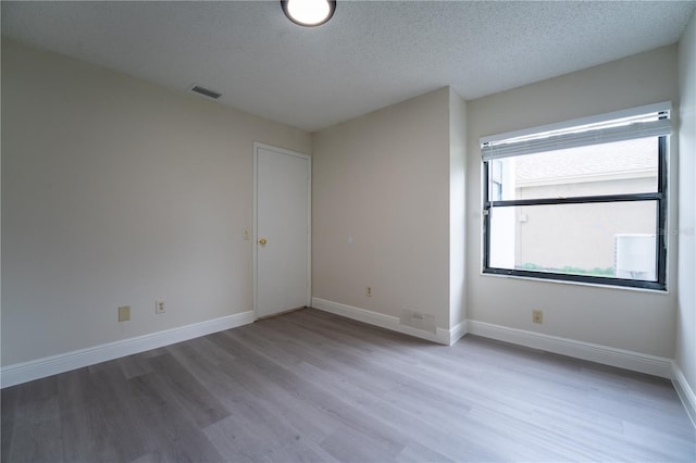 6019 Crystal View Dr, Orlando, FL 32819 - spare room with wood finished floors and a textured ceiling