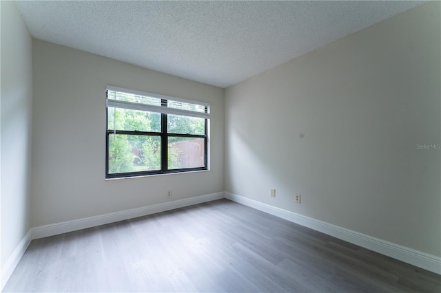6019 Crystal View Dr, Orlando, FL 32819 - unfurnished room featuring wood finished floors and a textured ceiling
