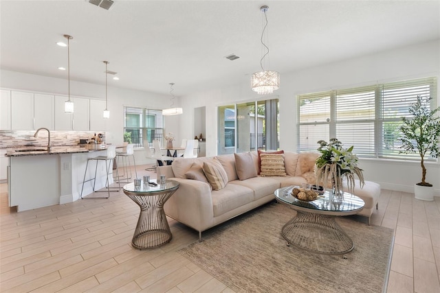15448 Murcott Blossom Blvd, Winter Garden, FL 34787 - living area with light wood finished floors, recessed lighting, and a chandelier
