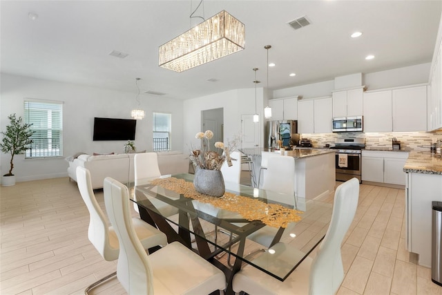 15448 Murcott Blossom Blvd, Winter Garden, FL 34787 - dining space featuring a chandelier, plenty of natural light, recessed lighting, and light wood-style flooring