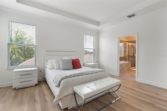 15448 Murcott Blossom Blvd, Winter Garden, FL 34787 - bedroom with a raised ceiling, light wood-type flooring, crown molding, and connected bathroom
