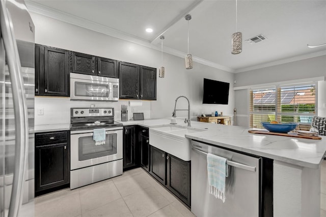 1191 Honey Blossom Dr Unit D, Orlando, FL 32824 - kitchen featuring stainless steel appliances, dark cabinets, light tile patterned flooring, crown molding, and recessed lighting