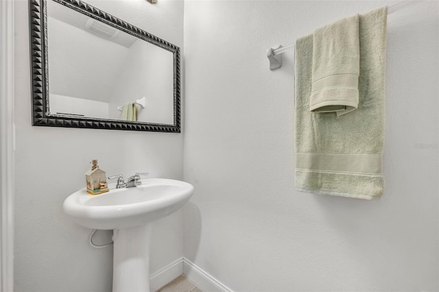 1191 Honey Blossom Dr Unit D, Orlando, FL 32824 - bathroom featuring baseboards and a sink