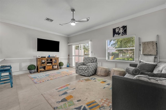 1191 Honey Blossom Dr Unit D, Orlando, FL 32824 - tiled living area featuring crown molding, a ceiling fan, a decorative wall, and a wainscoted wall