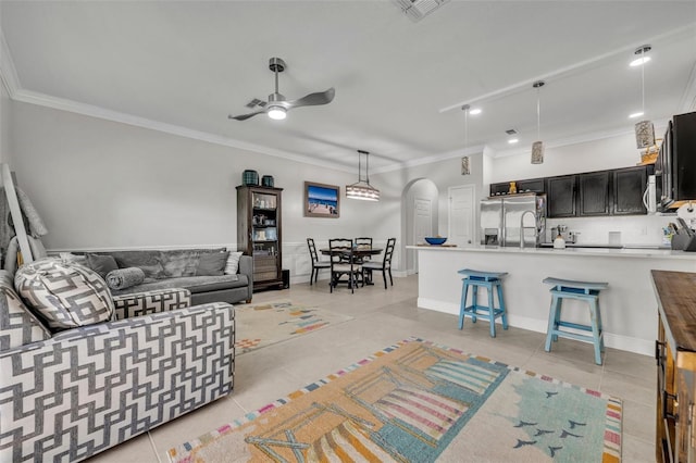 1191 Honey Blossom Dr Unit D, Orlando, FL 32824 - living area featuring crown molding, light tile patterned flooring, a ceiling fan, arched walkways, and recessed lighting