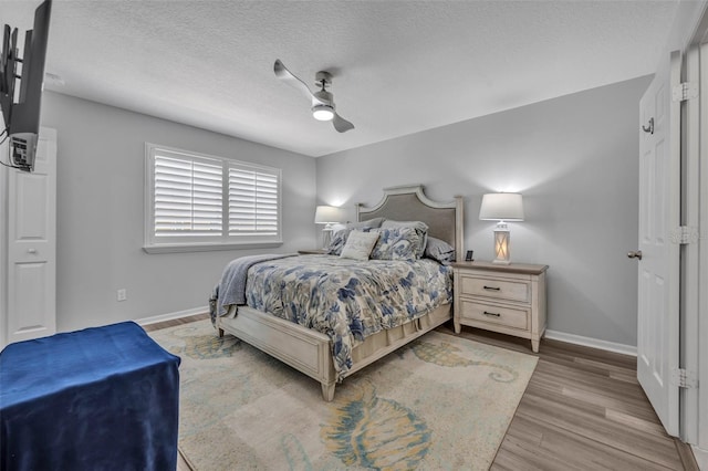 1191 Honey Blossom Dr Unit D, Orlando, FL 32824 - bedroom featuring wood finished floors, a textured ceiling, and a ceiling fan