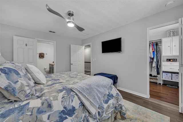 1191 Honey Blossom Dr Unit D, Orlando, FL 32824 - bedroom with a walk in closet, dark wood-style floors, a ceiling fan, and a closet