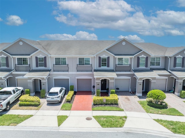 1191 Honey Blossom Dr Unit D, Orlando, FL 32824 - townhome / multi-family property with a garage, driveway, and stucco siding