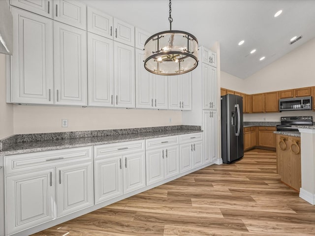 1111 Liberty Hall Dr, Kissimmee, FL 34746 - kitchen featuring appliances with stainless steel finishes, a chandelier, light wood-style flooring, recessed lighting, and brown cabinets
