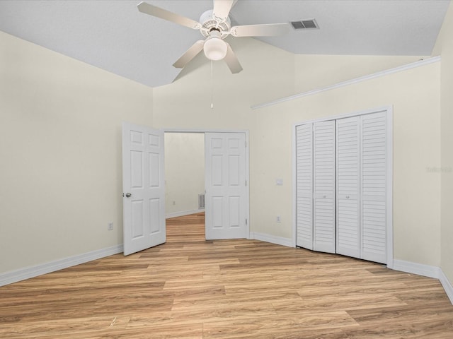 1111 Liberty Hall Dr, Kissimmee, FL 34746 - unfurnished bedroom featuring light wood-style flooring, a closet, high vaulted ceiling, and a ceiling fan