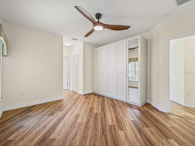 1111 Liberty Hall Dr, Kissimmee, FL 34746 - unfurnished bedroom with wood finished floors and ceiling fan