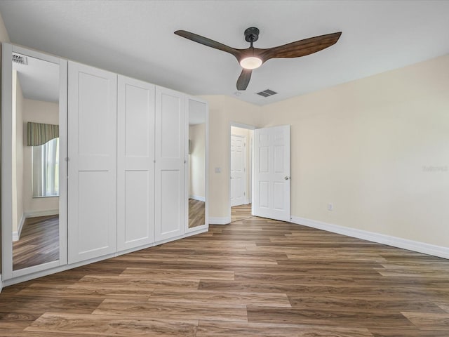 1111 Liberty Hall Dr, Kissimmee, FL 34746 - unfurnished bedroom featuring wood finished floors, a closet, and ceiling fan