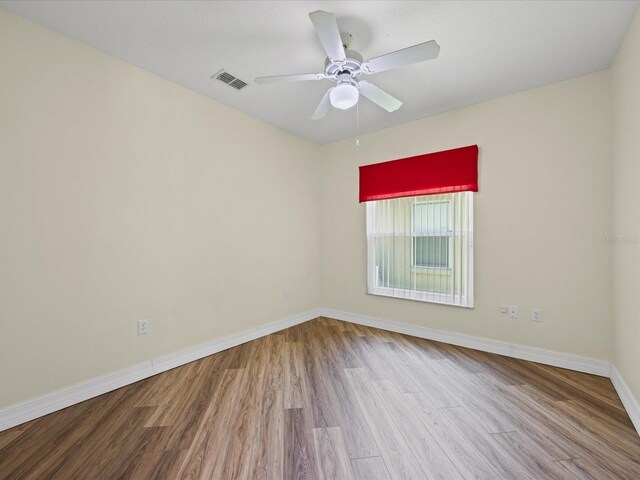 1111 Liberty Hall Dr, Kissimmee, FL 34746 - unfurnished room with wood finished floors and a ceiling fan