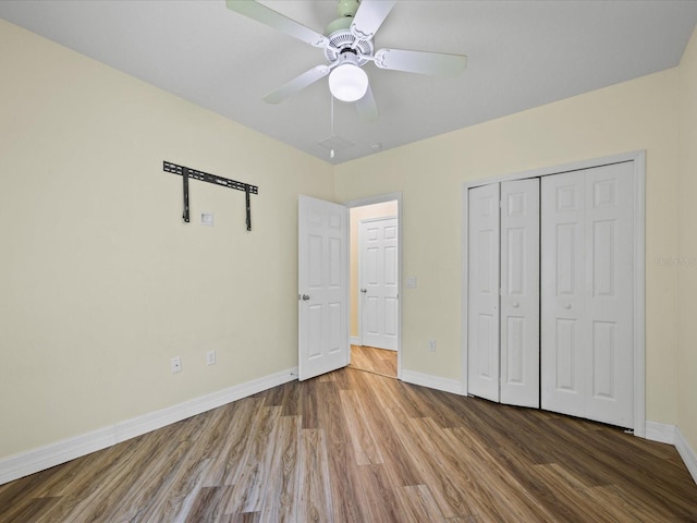 1111 Liberty Hall Dr, Kissimmee, FL 34746 - unfurnished bedroom with wood finished floors, a closet, and ceiling fan