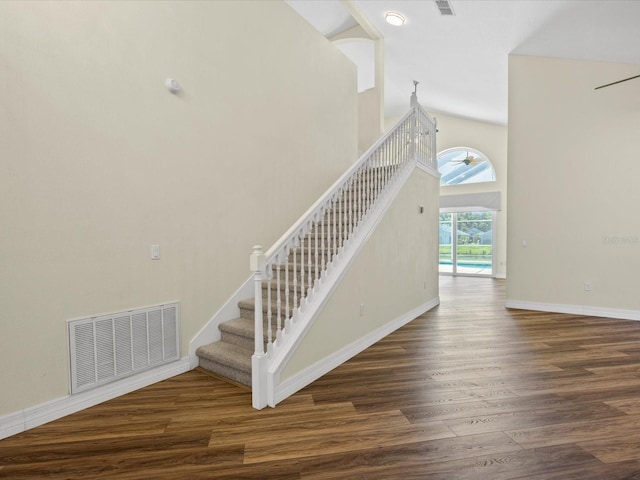 1111 Liberty Hall Dr, Kissimmee, FL 34746 - staircase featuring wood finished floors and high vaulted ceiling