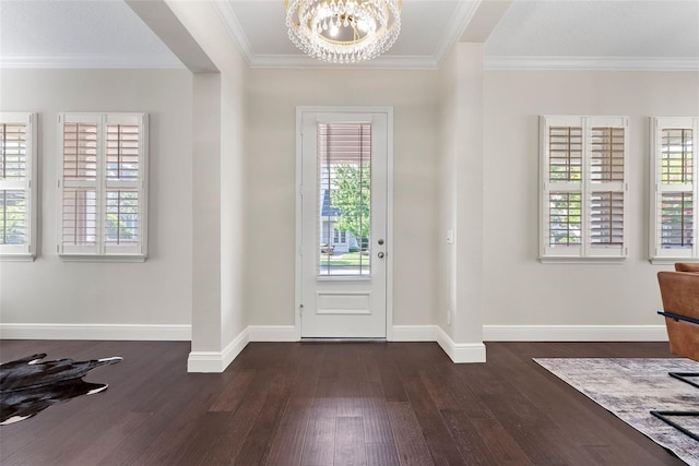 4310 Ethan Ln, Orlando, FL 32814 - foyer with dark wood-style flooring, a chandelier, and ornamental molding