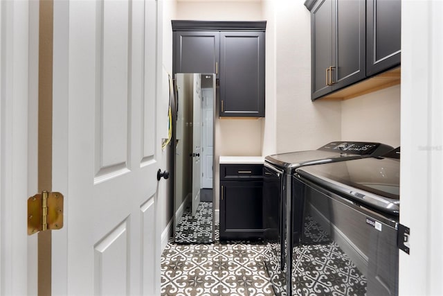 4310 Ethan Ln, Orlando, FL 32814 - washroom with cabinet space, washing machine and clothes dryer, and light tile patterned flooring