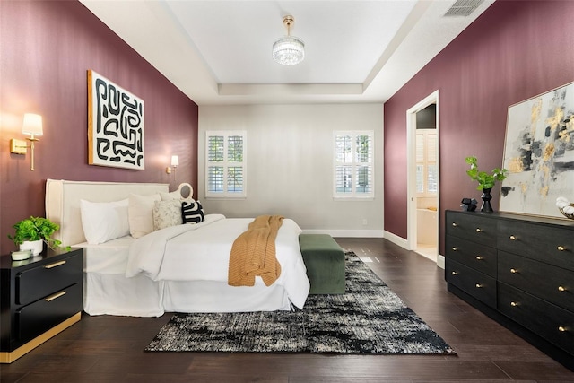 4310 Ethan Ln, Orlando, FL 32814 - bedroom featuring a tray ceiling, wood finished floors, and connected bathroom