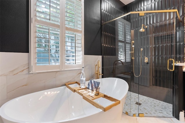 4310 Ethan Ln, Orlando, FL 32814 - full bath featuring a freestanding tub, tile walls, and a shower stall