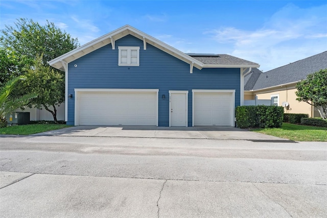 4310 Ethan Ln, Orlando, FL 32814 - view of front of property featuring concrete driveway, solar panels, and a garage