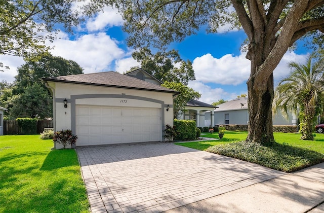1173 Valley Creek Run, Winter Park, FL 32792 - ranch-style house with stucco siding, a garage, decorative driveway, and a front lawn