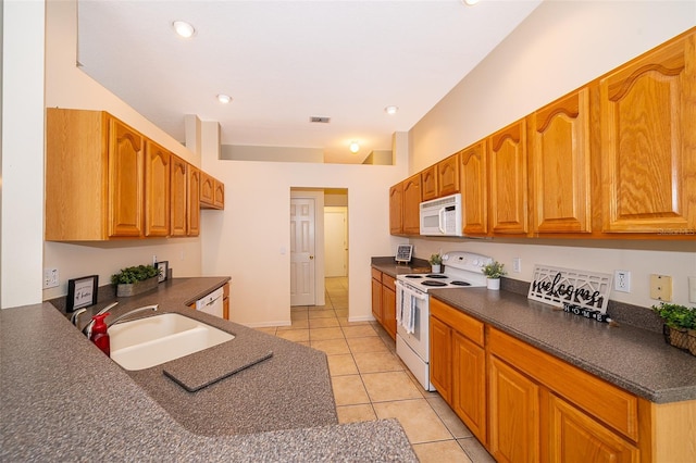 1173 Valley Creek Run, Winter Park, FL 32792 - kitchen with white appliances, dark countertops, light tile patterned flooring, brown cabinetry, and recessed lighting