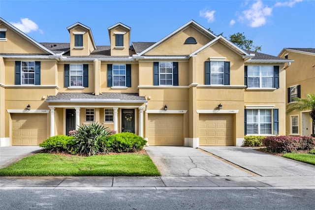 1534 Barking Deer Cv, Casselberry, FL 32707 - townhome / multi-family property with driveway, an attached garage, and stucco siding